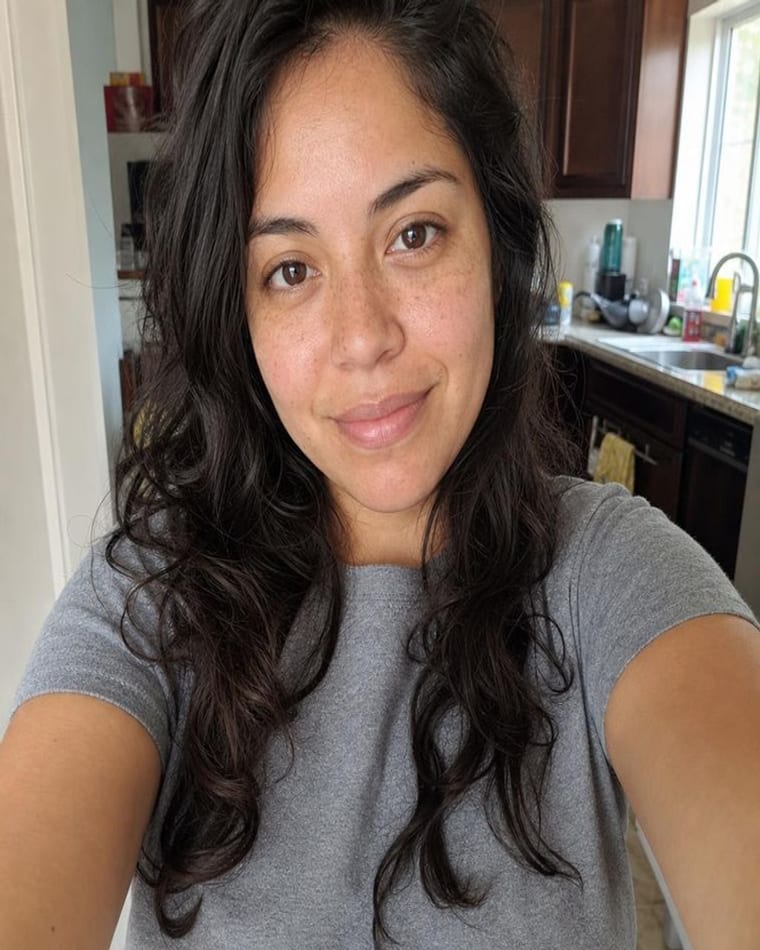 An everyday phone selfie taken in a kitchen, of the kind already in a camera roll.